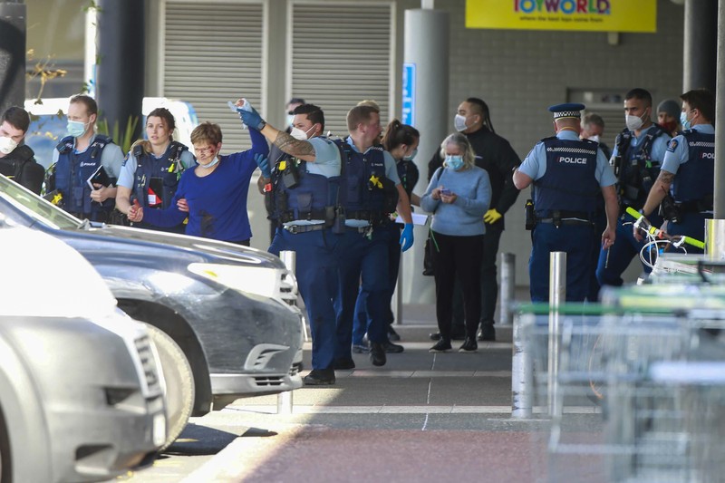 A police officer stands outside an Auckland supermarket, Friday, Sept. 3, 2021. New Zealand authorities said Friday they shot and killed a violent extremist after he entered a supermarket and stabbed and injured several shoppers. Prime Minister Jacinda Ardern described the incident as a terror attack. (Alex Burton/New Zealand Herald via AP)
