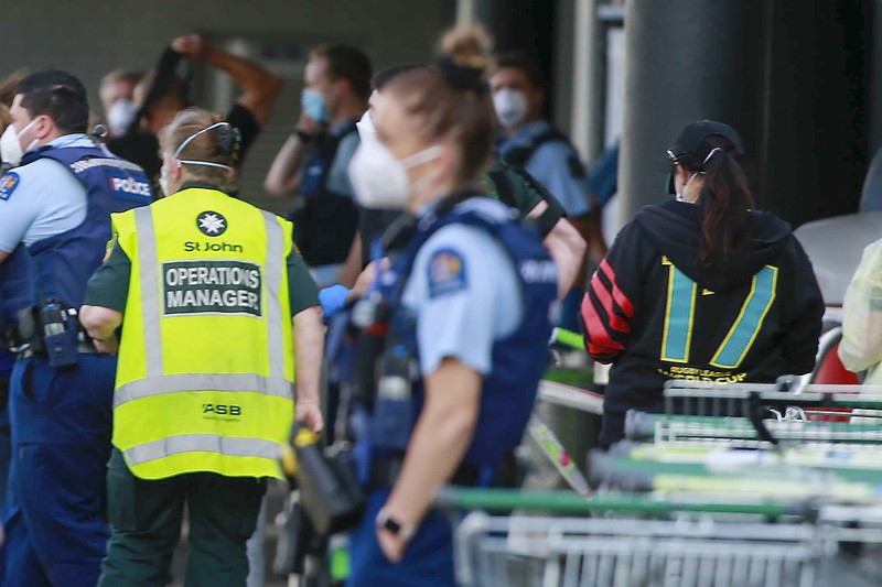 A police officer stands outside an Auckland supermarket, Friday, Sept. 3, 2021. New Zealand authorities said Friday they shot and killed a violent extremist after he entered a supermarket and stabbed and injured several shoppers. Prime Minister Jacinda Ardern described the incident as a terror attack. (Alex Burton/New Zealand Herald via AP)