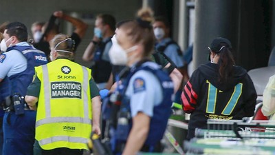 Police and ambulance staff attend a scene outside an Auckland supermarket, Friday, Sep. 3, 2021. New Zealand authorities say they shot and killed a violent extremist after he entered a supermarket and stabbed and injured six shoppers. Prime Minister Jacinda Ardern described Friday's incident as a terror attack. (Alex Burton/New Zealand Herald via AP)