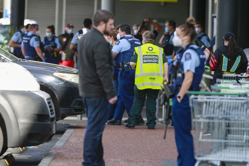 A police officer stands outside an Auckland supermarket, Friday, Sept. 3, 2021. New Zealand authorities said Friday they shot and killed a violent extremist after he entered a supermarket and stabbed and injured several shoppers. Prime Minister Jacinda Ardern described the incident as a terror attack. (Alex Burton/New Zealand Herald via AP)