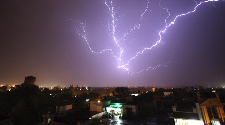 A bolt of lightning strikes in the horizon over Jammu, India during a summer storm on Monday, May 9, 2011, (AP Photo/ Channi Anand)