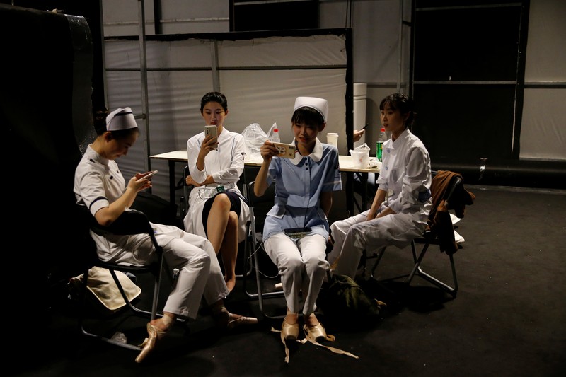 China Fashion Week Busana Medis A model waits backstage before a fashion show with creations for medical professionals, designed by the Beijing Institute of Fashion Technology in collaboration with Dishang, during China Fashion Week in Beijing, China September 11, 2021. REUTERS/Tingshu Wang