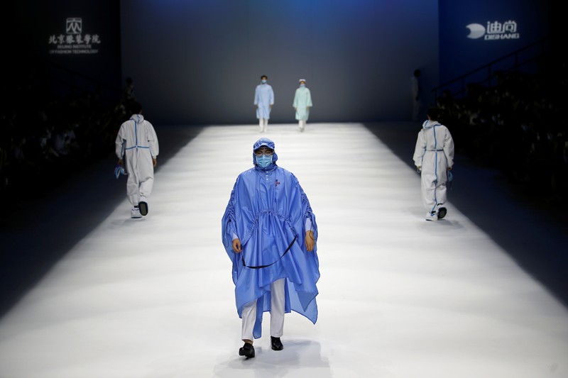 China Fashion Week Busana Medis A model waits backstage before a fashion show with creations for medical professionals, designed by the Beijing Institute of Fashion Technology in collaboration with Dishang, during China Fashion Week in Beijing, China September 11, 2021. REUTERS/Tingshu Wang