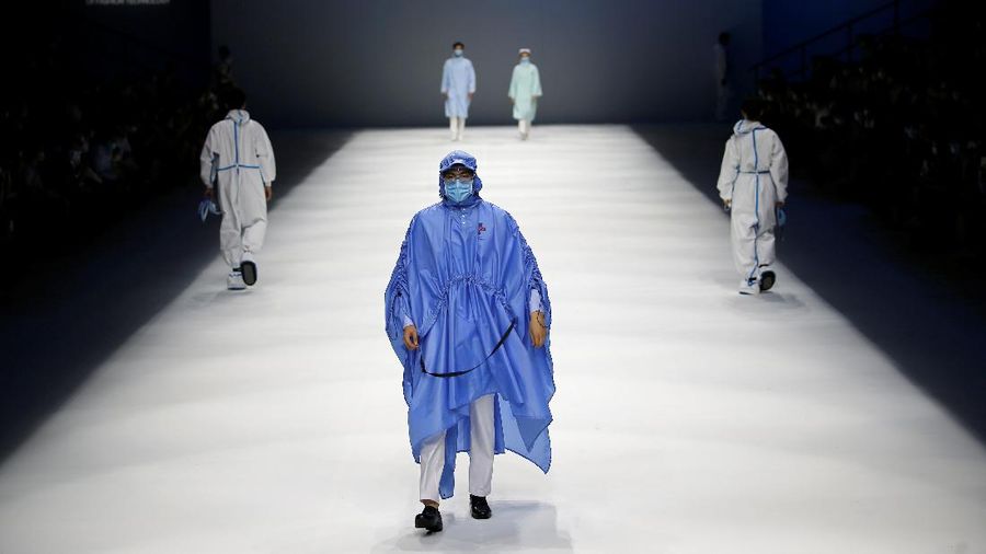 A model waits backstage before a fashion show with creations for medical professionals, designed by the Beijing Institute of Fashion Technology in collaboration with Dishang, during China Fashion Week in Beijing, China September 11, 2021. REUTERS/Tingshu Wang