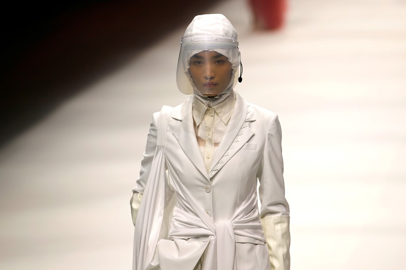 China Fashion Week Busana Medis A model waits backstage before a fashion show with creations for medical professionals, designed by the Beijing Institute of Fashion Technology in collaboration with Dishang, during China Fashion Week in Beijing, China September 11, 2021. REUTERS/Tingshu Wang