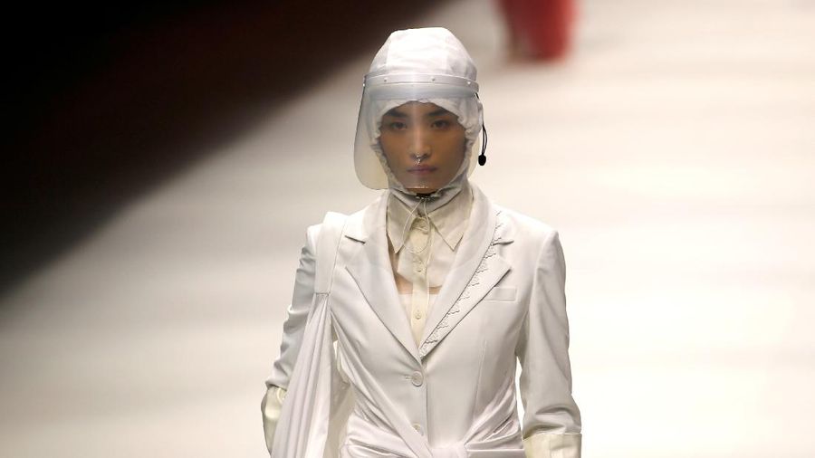 A model waits backstage before a fashion show with creations for medical professionals, designed by the Beijing Institute of Fashion Technology in collaboration with Dishang, during China Fashion Week in Beijing, China September 11, 2021. REUTERS/Tingshu Wang