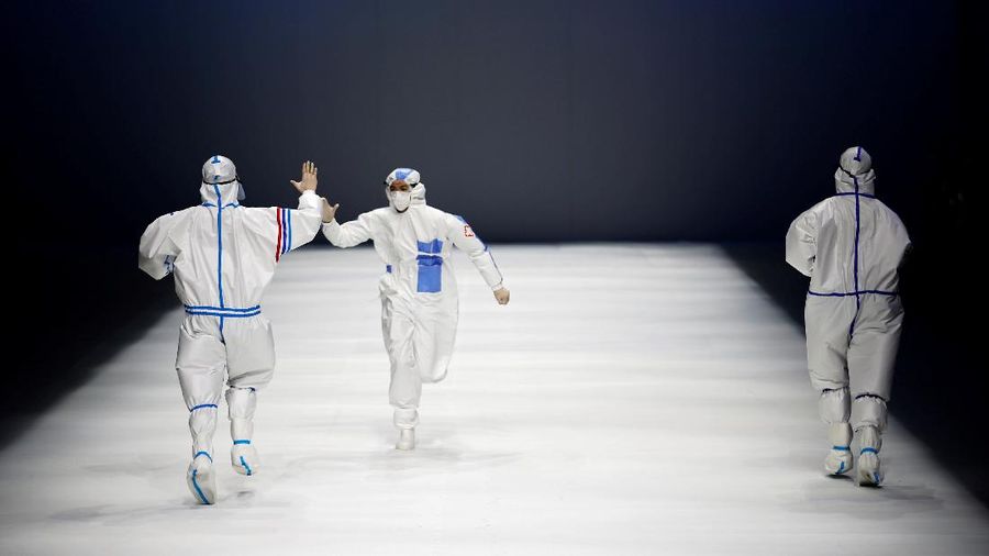 A model waits backstage before a fashion show with creations for medical professionals, designed by the Beijing Institute of Fashion Technology in collaboration with Dishang, during China Fashion Week in Beijing, China September 11, 2021. REUTERS/Tingshu Wang