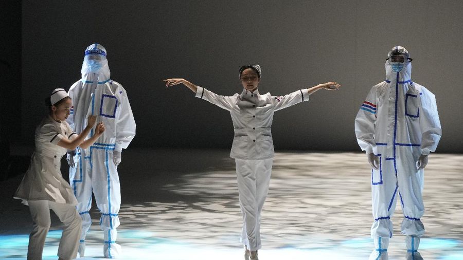 A model waits backstage before a fashion show with creations for medical professionals, designed by the Beijing Institute of Fashion Technology in collaboration with Dishang, during China Fashion Week in Beijing, China September 11, 2021. REUTERS/Tingshu Wang