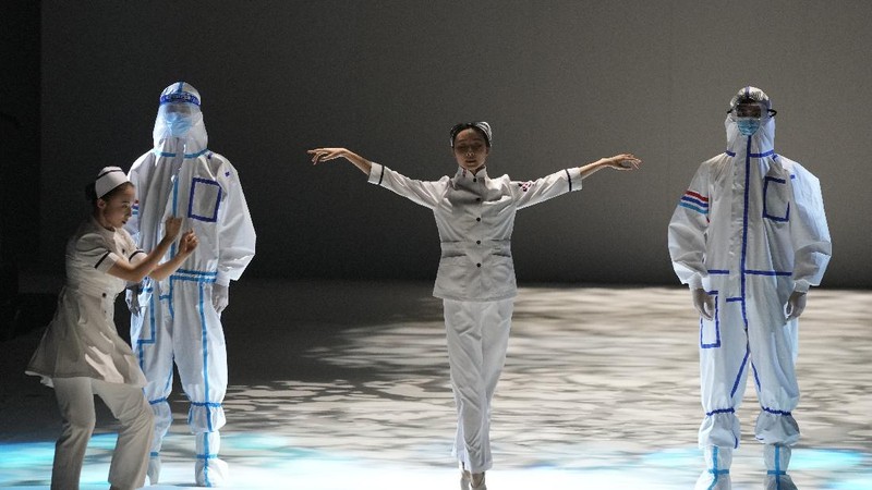 A model waits backstage before a fashion show with creations for medical professionals, designed by the Beijing Institute of Fashion Technology in collaboration with Dishang, during China Fashion Week in Beijing, China September 11, 2021. REUTERS/Tingshu Wang