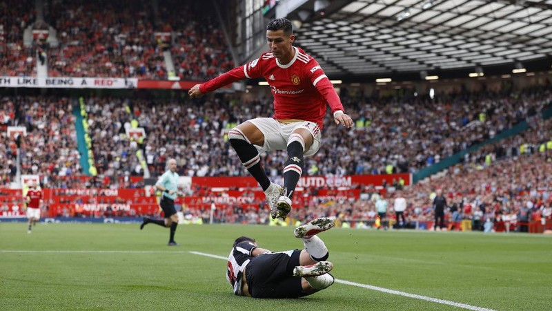 Soccer Football - Premier League - Manchester United v Newcastle United - Old Trafford, Manchester, Britain - September 11, 2021 Manchester United's Cristiano Ronaldo in action with Newcastle United's Joe Willock REUTERS/Phil Noble EDITORIAL USE ONLY. No use with unauthorized audio, video, data, fixture lists, club/league logos or 'live' services. Online in-match use limited to 75 images, no video emulation. No use in betting, games or single club /league/player publications.  Please contact your account representative for further details.