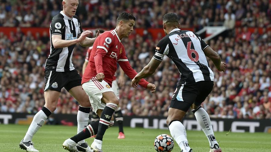 Soccer Football - Premier League - Manchester United v Newcastle United - Old Trafford, Manchester, Britain - September 11, 2021 Manchester United's Cristiano Ronaldo in action with Newcastle United's Joe Willock REUTERS/Phil Noble EDITORIAL USE ONLY. No use with unauthorized audio, video, data, fixture lists, club/league logos or 'live' services. Online in-match use limited to 75 images, no video emulation. No use in betting, games or single club /league/player publications.  Please contact your account representative for further details.