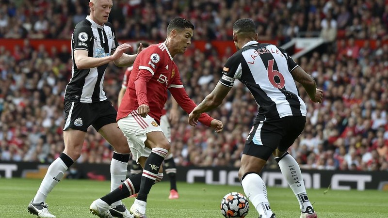 Soccer Football - Premier League - Manchester United v Newcastle United - Old Trafford, Manchester, Britain - September 11, 2021 Manchester United's Cristiano Ronaldo in action with Newcastle United's Joe Willock REUTERS/Phil Noble EDITORIAL USE ONLY. No use with unauthorized audio, video, data, fixture lists, club/league logos or 'live' services. Online in-match use limited to 75 images, no video emulation. No use in betting, games or single club /league/player publications.  Please contact your account representative for further details.