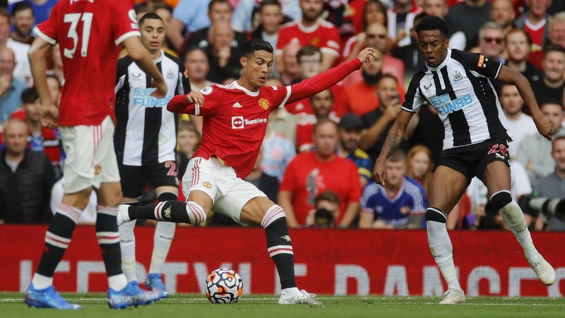 Soccer Football - Premier League - Manchester United v Newcastle United - Old Trafford, Manchester, Britain - September 11, 2021 Manchester United's Cristiano Ronaldo in action with Newcastle United's Joe Willock REUTERS/Phil Noble EDITORIAL USE ONLY. No use with unauthorized audio, video, data, fixture lists, club/league logos or 'live' services. Online in-match use limited to 75 images, no video emulation. No use in betting, games or single club /league/player publications.  Please contact your account representative for further details.