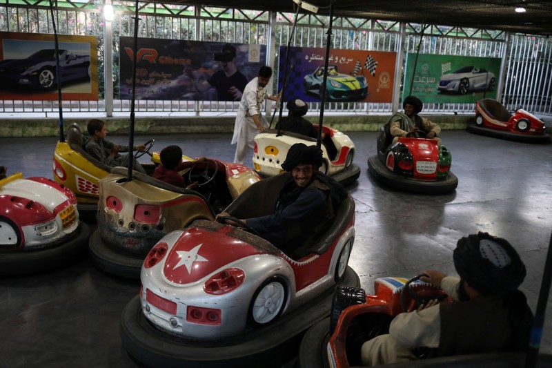 Taliban soldiers ride bumper cars in an amusement park in Kabul, Afghanistan, September 13, 2021. WANA (West Asia News Agency) via REUTERS ATTENTION EDITORS - THIS IMAGE HAS BEEN SUPPLIED BY A THIRD PARTY.