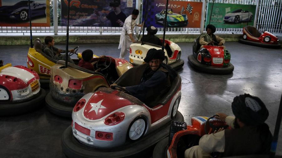 Taliban soldiers ride bumper cars in an amusement park in Kabul, Afghanistan, September 13, 2021. WANA (West Asia News Agency) via REUTERS ATTENTION EDITORS - THIS IMAGE HAS BEEN SUPPLIED BY A THIRD PARTY.