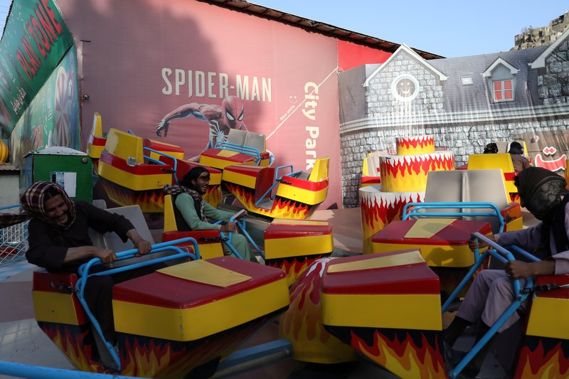 AFGHANISTAN-CONFLICT/ Taliban soldiers ride bumper cars in an amusement park in Kabul, Afghanistan, September 13, 2021. WANA (West Asia News Agency) via REUTERS ATTENTION EDITORS - THIS IMAGE HAS BEEN SUPPLIED BY A THIRD PARTY.