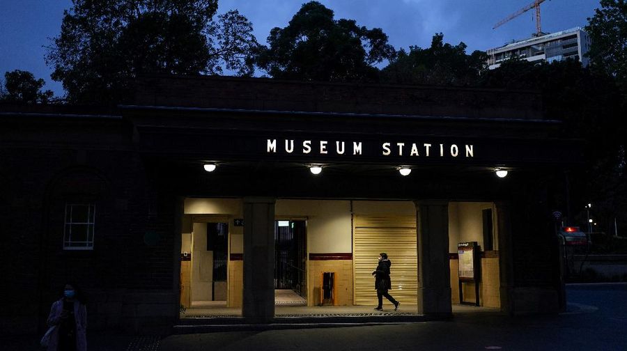 A person in protective face mask enters a train station at dusk in the city centre during a lockdown to curb the spread of a coronavirus disease (COVID-19) outbreak in Sydney, Australia, September 14, 2021. REUTERS/Loren Elliott
