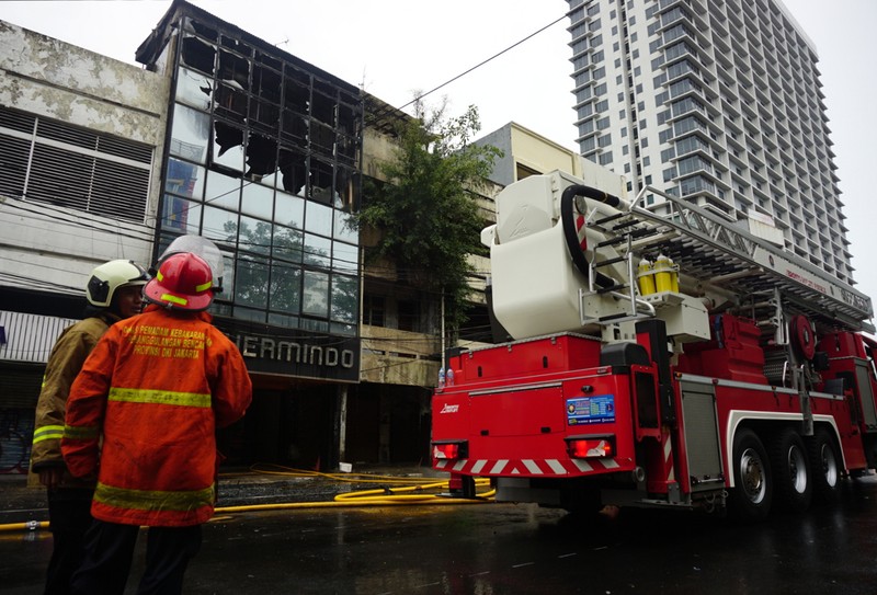 Petugas kebakaran masih berupaya memadamkan api didalam ruko yang terbakar di depan LTC Glodok, Jakarta, Selasa (14/9/2021) Ada 26 unit mobil kebakaran yang dikerahkan dilokasi kebakaran. Pantauan dilokasi api sudah berhasil dipadamkan.  (CNBC Indonesia/Tri Susilo)