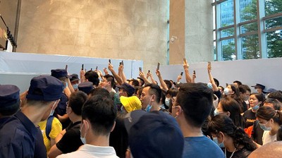 FILE PHOTO: People gather to demand repayment of loans and financial products at the lobby of Evergrande's Shenzhen headquarter, Guangdong province, China September 13, 2021. REUTERS/David Kirton/File Photo