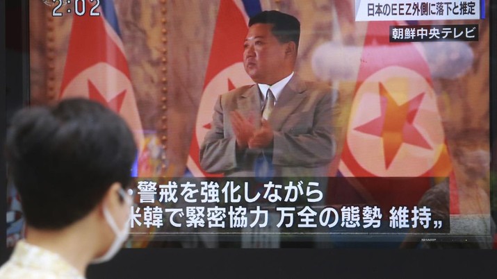 A man walks past a TV screen showing North Korean leader Kim Jong Un, in Tokyo, Wednesday, Sept. 15, 2021. North Korea fired two ballistic missiles into waters off its eastern coast Wednesday afternoon, two days after claiming to have tested a newly developed missile in a resumption of its weapons displays after a six-month lull. (AP Photo/Koji Sasahara)