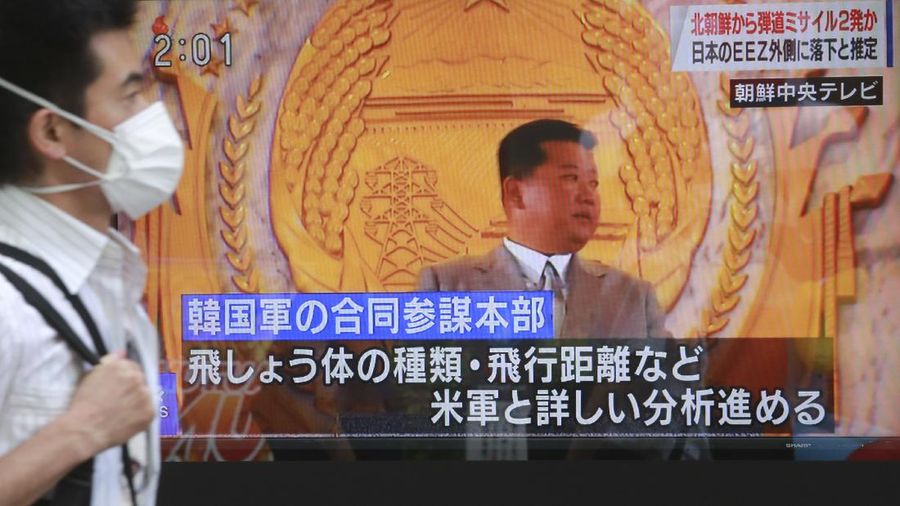 A man walks past a TV screen showing North Korean leader Kim Jong Un, in Tokyo, Wednesday, Sept. 15, 2021. North Korea fired two ballistic missiles into waters off its eastern coast Wednesday afternoon, two days after claiming to have tested a newly developed missile in a resumption of its weapons displays after a six-month lull. Letters, bottom, read 