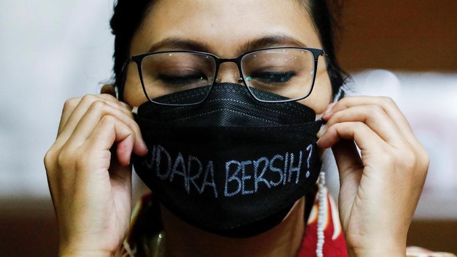A man takes pictures on a smartphone during the hearing of a citizen lawsuit, done in an attempt to sue the government into taking action on the city's chronic levels of air pollution, at the Central Jakarta Court, Indonesia, September 16, 2021. REUTERS/Willy Kurniawan   REFILE - QUALITY REPEAT