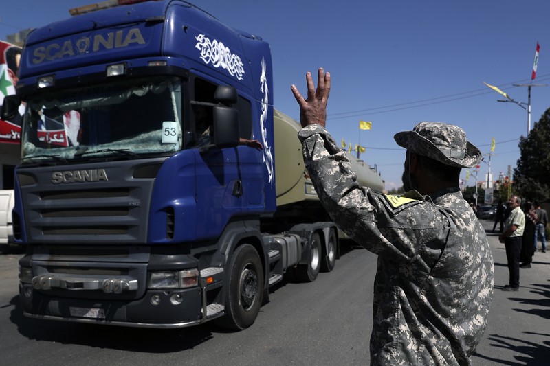 Lebanon Iran Fuel A convoy of tanker trucks carrying Iranian diesel crossing the border from Syria into Lebanon, arrive at the eastern town of el-Ain, Lebanon, Thursday, Sept. 16, 2021. The delivery, organized by the Iranian-backed Hezbollah group, violates U.S. sanctions imposed on Tehran after former President Donald Trump pulled America out of a nuclear deal between Iran and world powers three years ago. (AP Photo/Bilal Hussein)
