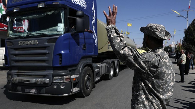 A convoy of tanker trucks carrying Iranian diesel crossing the border from Syria into Lebanon, arrive at the eastern town of el-Ain, Lebanon, Thursday, Sept. 16, 2021. The delivery, organized by the Iranian-backed Hezbollah group, violates U.S. sanctions imposed on Tehran after former President Donald Trump pulled America out of a nuclear deal between Iran and world powers three years ago. (AP Photo/Bilal Hussein)