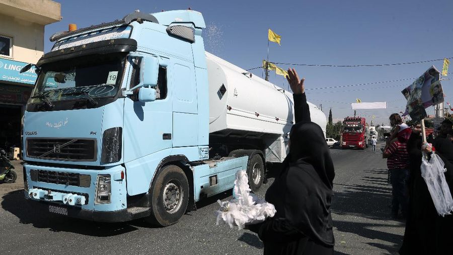 A convoy of tanker trucks carrying Iranian diesel crossing the border from Syria into Lebanon, arrive at the eastern town of el-Ain, Lebanon, Thursday, Sept. 16, 2021. The delivery, organized by the Iranian-backed Hezbollah group, violates U.S. sanctions imposed on Tehran after former President Donald Trump pulled America out of a nuclear deal between Iran and world powers three years ago. (AP Photo/Bilal Hussein)