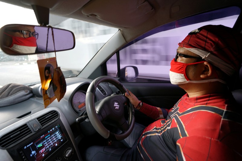 Agus Widanarko, 40, wears a Spiderman costume while driving as he prepares to entertain children confined to their homes due to coronavirus disease (COVID-19) restrictions, in Sukoharjo, Central Java province, Indonesia, September 10, 2021. Picture taken September 10, 2021. REUTERS/Stringer NO RESALES. NO ARCHIVES