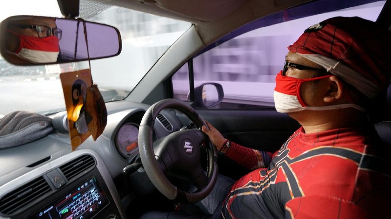 Agus Widanarko, 40, wears a Spiderman costume while driving as he prepares to entertain children confined to their homes due to coronavirus disease (COVID-19) restrictions, in Sukoharjo, Central Java province, Indonesia, September 10, 2021. Picture taken September 10, 2021. REUTERS/Stringer NO RESALES. NO ARCHIVES