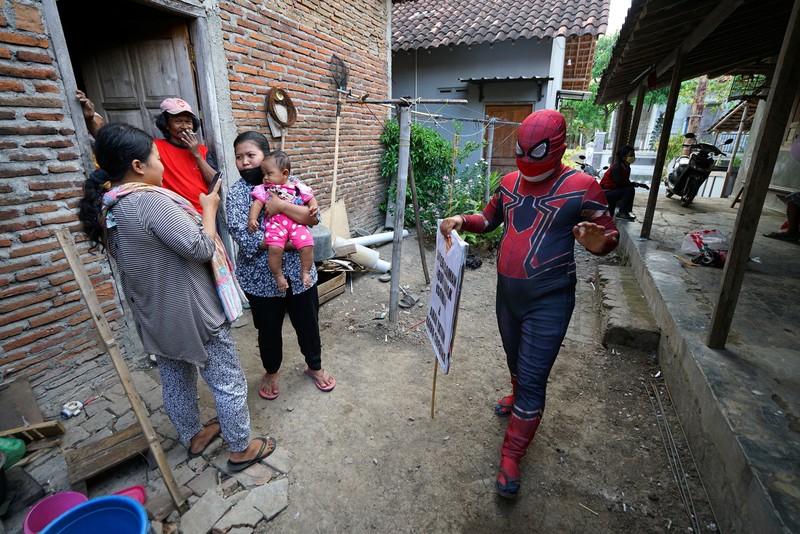 Agus Widanarko, 40, wears a Spiderman costume while driving as he prepares to entertain children confined to their homes due to coronavirus disease (COVID-19) restrictions, in Sukoharjo, Central Java province, Indonesia, September 10, 2021. Picture taken September 10, 2021. REUTERS/Stringer NO RESALES. NO ARCHIVES