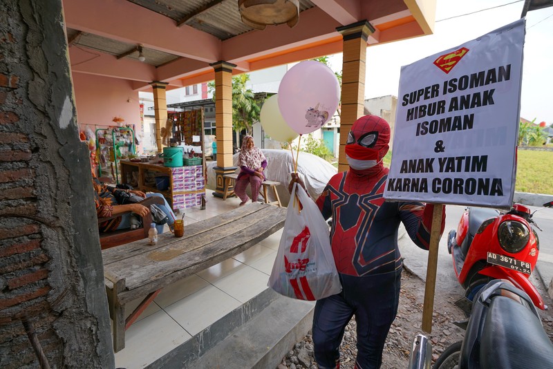 Agus Widanarko, 40, wears a Spiderman costume while driving as he prepares to entertain children confined to their homes due to coronavirus disease (COVID-19) restrictions, in Sukoharjo, Central Java province, Indonesia, September 10, 2021. Picture taken September 10, 2021. REUTERS/Stringer NO RESALES. NO ARCHIVES