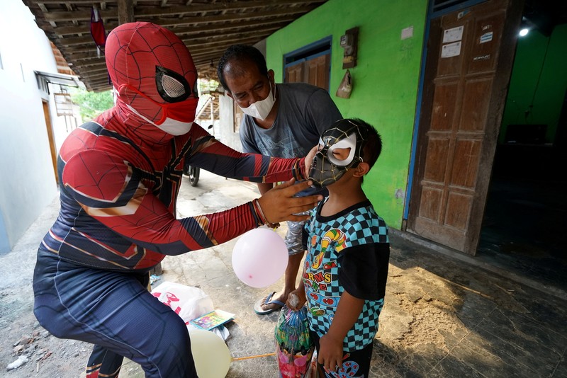 Agus Widanarko, 40, wears a Spiderman costume while driving as he prepares to entertain children confined to their homes due to coronavirus disease (COVID-19) restrictions, in Sukoharjo, Central Java province, Indonesia, September 10, 2021. Picture taken September 10, 2021. REUTERS/Stringer NO RESALES. NO ARCHIVES