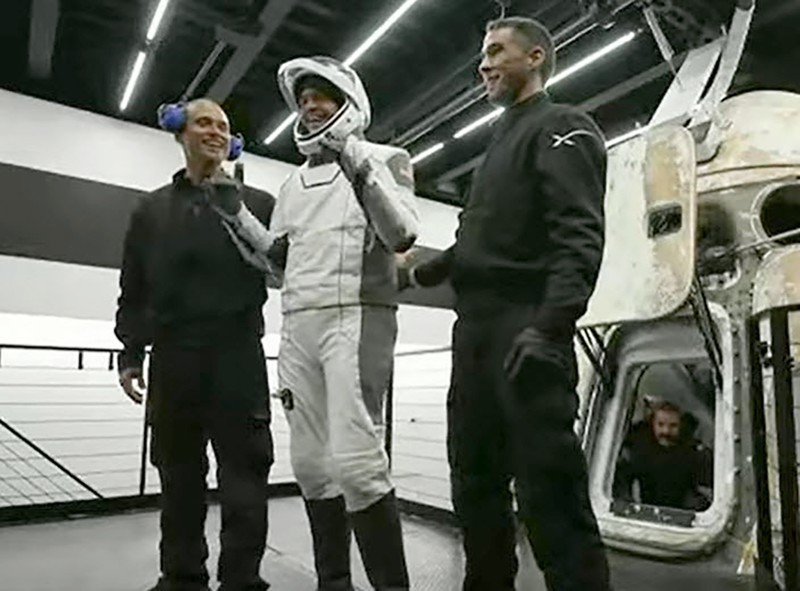 In this image taken from SpaceX video, passengers aboard a SpaceX capsule react as the capsule parachutes into the Atlantic Ocean off the Florida coast, Saturday, Sept. 18, 2021. The all-amateur crew was the first to circle the world without a professional astronaut.  (SpaceX via AP)
