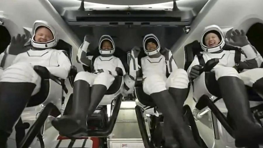 In this image taken from SpaceX video, passengers aboard a SpaceX capsule react as the capsule parachutes into the Atlantic Ocean off the Florida coast, Saturday, Sept. 18, 2021. The all-amateur crew was the first to circle the world without a professional astronaut.  (SpaceX via AP)