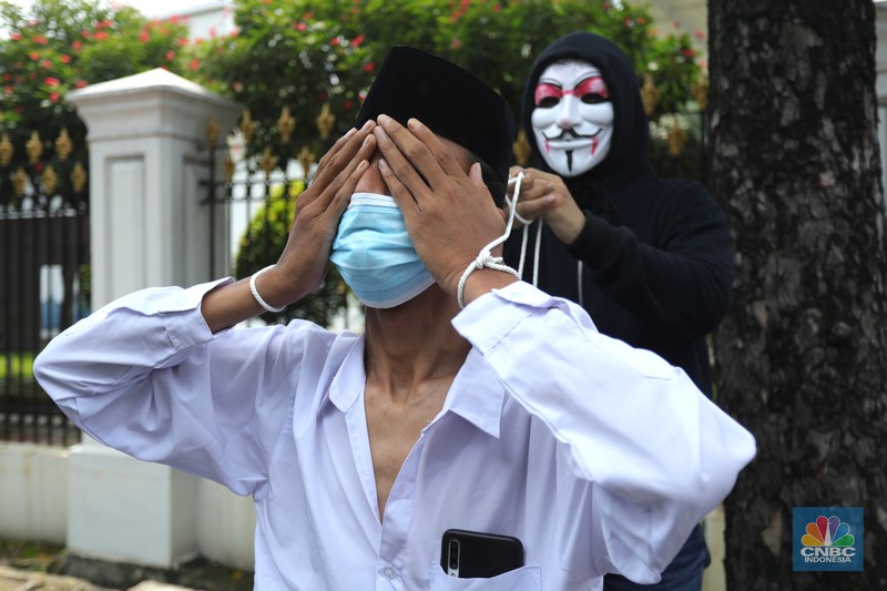 Sejumlah aliansi petani tembakau Indonesia menggelar aksi treatrikal didepan pintu masuk Sekertaris Presiden (SEKNEG), Jakarta, Senin (20/9/2021). Rencana kenaikan cukai rokok tahun depan menimbulkan kekhawatiran serapan tembakau petani dari industri hasil tembakau (IHT) turun. Dampak tersebut membuat etani tembakau semakin merana karena harga jual tembakau di tingkat petani mengalami penurunan. Pantauan dilokasi aksi teater ikal bejalan hanya beberapa menit dan langsung dibubarkan oleh pihak pengaman Sekneg. Sebelumnya kordinator aksi melakukan mediasi kedalam pagar untuk bisa mendapatkan izin kepada pihak pengaman setempat.  (CNBC Indonesia/ Tri Susilo)