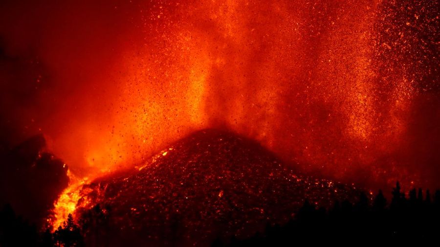 Residents watch lava following the eruption of a volcano in the Cumbre Vieja national park at El Paso, on the Canary Island of La Palma, September 19, 2021. Pictures taken September 19, 2021. REUTERS/Borja Suarez