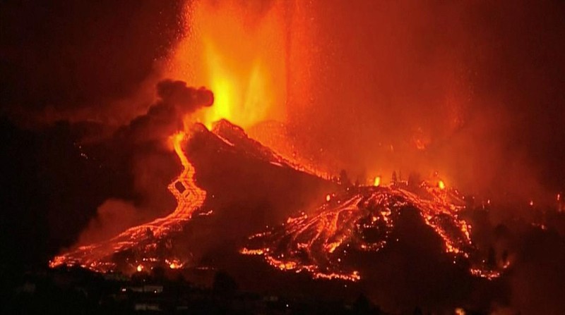 Residents watch lava following the eruption of a volcano in the Cumbre Vieja national park at El Paso, on the Canary Island of La Palma, September 19, 2021. Pictures taken September 19, 2021. REUTERS/Borja Suarez