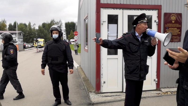 Police block the road near the scene after a gunman opened fire at the Perm State University in Perm, Russia September 20, 2021, in this still image taken from video. REUTERS/Anna Vikhareva NO RESALES. NO ARCHIVES