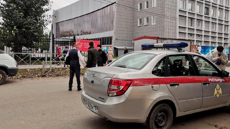 Police block the road near the scene after a gunman opened fire at the Perm State University in Perm, Russia September 20, 2021, in this still image taken from video. REUTERS/Anna Vikhareva NO RESALES. NO ARCHIVES