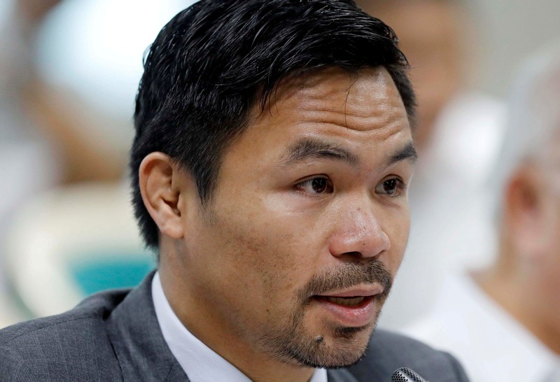 FILE - Manny Pacquiao reacts after defeating Keith Thurman by split decision in a welterweight title fight in Las Vegas, in this Saturday, July 20, 2019, file photo. Pacquiao could have canceled his comeback from a two-year ring layoff when Errol Spence Jr. dropped out less than two weeks before their Aug. 21 fight. Instead, the Filipino congressman gave a career-defining opportunity to Yordenis Ugás, a Cuban veteran who now has the welterweight title belt Pacquiao recently held. (AP Photo/John Locher, File)
