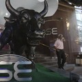 A man walks near the bronze statue of a bull outside the Bombay Stock Exchange (BSE) in Mumbai, India, Thursday, Oct. 4, 2018. Shares sank in India on concerns over continued weakness in the rupee and over the country's trade deficit thanks to surgin