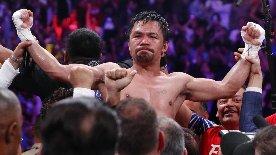 FILE - Manny Pacquiao reacts after defeating Keith Thurman by split decision in a welterweight title fight in Las Vegas, in this Saturday, July 20, 2019, file photo. Pacquiao could have canceled his comeback from a two-year ring layoff when Errol Spence Jr. dropped out less than two weeks before their Aug. 21 fight. Instead, the Filipino congressman gave a career-defining opportunity to Yordenis Ugás, a Cuban veteran who now has the welterweight title belt Pacquiao recently held. (AP Photo/John Locher, File)