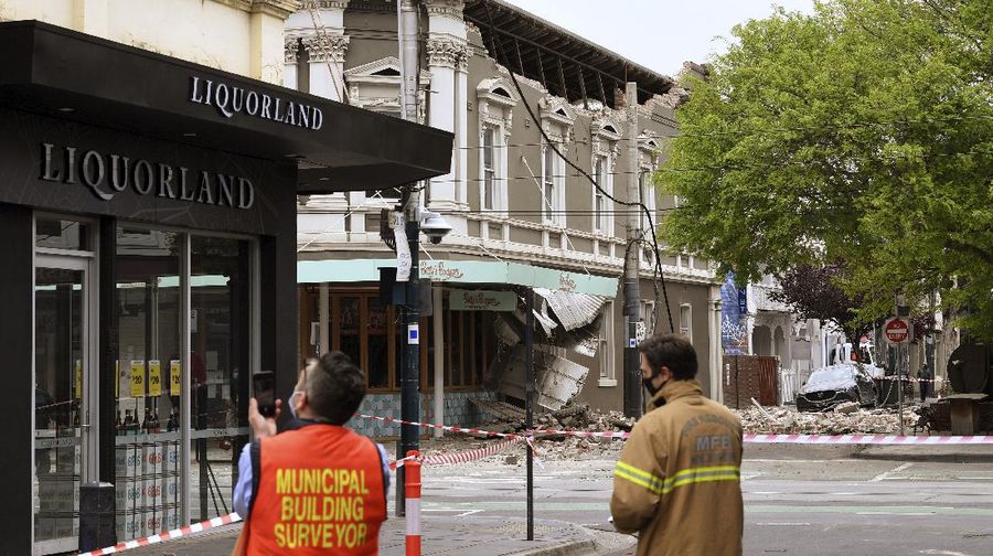 A person walks past damage to the exterior of a restaurant following an earthquake in the Windsor suburb of Melbourne, Australia, September 22, 2021.  AAP Image/James Ross via REUTERS  ATTENTION EDITORS - THIS IMAGE WAS PROVIDED BY A THIRD PARTY. NO RESALES. NO ARCHIVES. AUSTRALIA OUT. NEW ZEALAND OUT