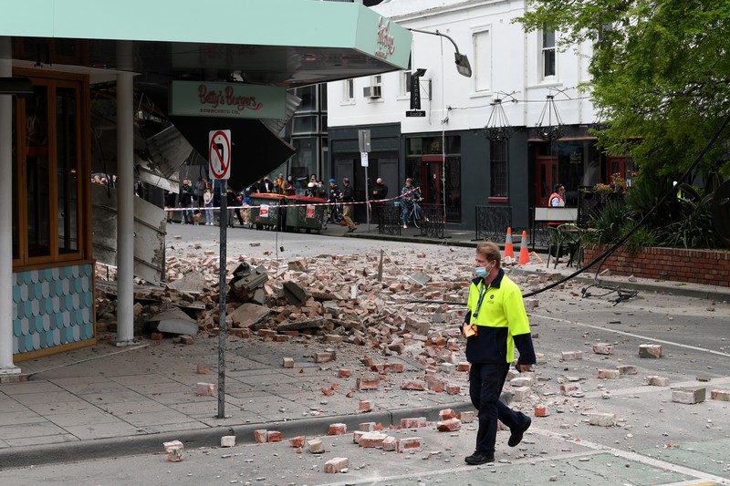 A person walks past damage to the exterior of a restaurant following an earthquake in the Windsor suburb of Melbourne, Australia, September 22, 2021.  AAP Image/James Ross via REUTERS  ATTENTION EDITORS - THIS IMAGE WAS PROVIDED BY A THIRD PARTY. NO RESALES. NO ARCHIVES. AUSTRALIA OUT. NEW ZEALAND OUT