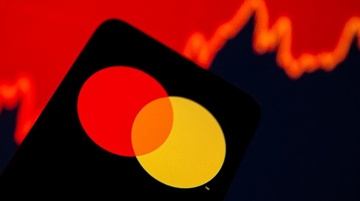 FILE PHOTO: Smartphone with Mastercard logo is seen in front of displayed stock graph in this illustration taken, July 15, 2021. REUTERS/Dado Ruvic/Illustration/File Photo
