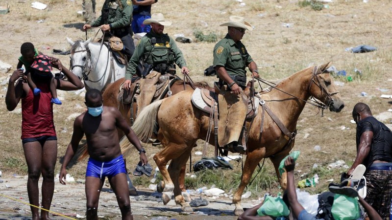 U.S. Customs and Border Protection mounted officers attempt to contain migrants as they cross the Rio Grande from Ciudad Acuna, Mexico, into Del Rio, Texas, Sunday, Sept. 19, 2021. Criticism has been fueled by the images that went viral this week of Border Patrol agents on horseback using aggressive tactics against the migrants. (AP Photo/Felix Marquez)