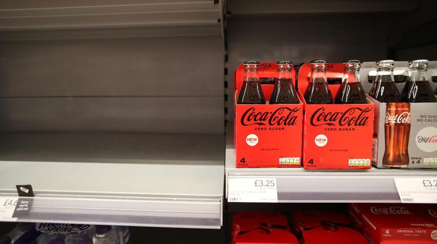 Empty shelves are seen in the soft drinks aisle of Co-Op supermarket, Harpenden, Britain, September 22, 2021. REUTERS/Peter Cziborra