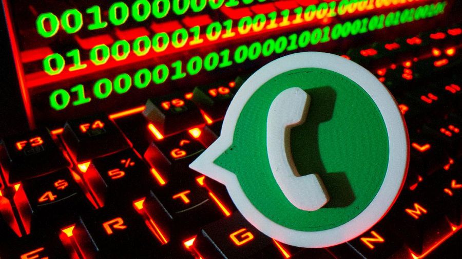 A 3D printed Whatsapp logo is pictured on a keyboard in front of binary code in this illustration taken September 24, 2021. REUTERS/Dado Ruvic/Illustration